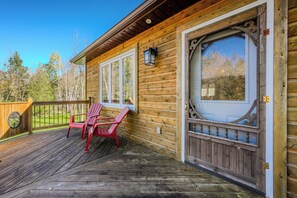A peaceful front deck with seating, perfect for enjoying your morning coffee or relaxing in the fresh air.