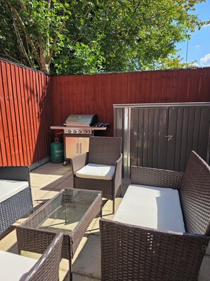 Private garden with BBQ and outdoor furniture