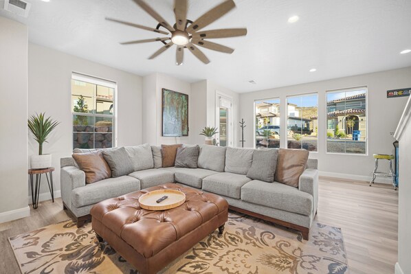 Bright living area with comfy seating and Smart TV