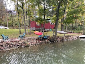 Lakeside with fire pit, kayaks, canoe and private dock.