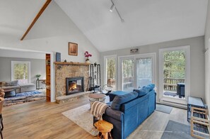 Living room with a fireplace and a beautiful view of the outdoor scenery
