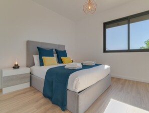 First Floor two bedroom apartment room with a queen size bed.