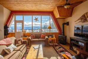 Features a gas fireplace. Patio + Hot tub entrance can be seen to the left of the photo.