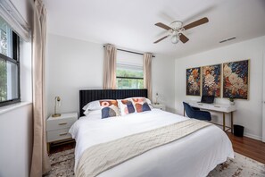 King Bed in Master bedroom with desk and chair.