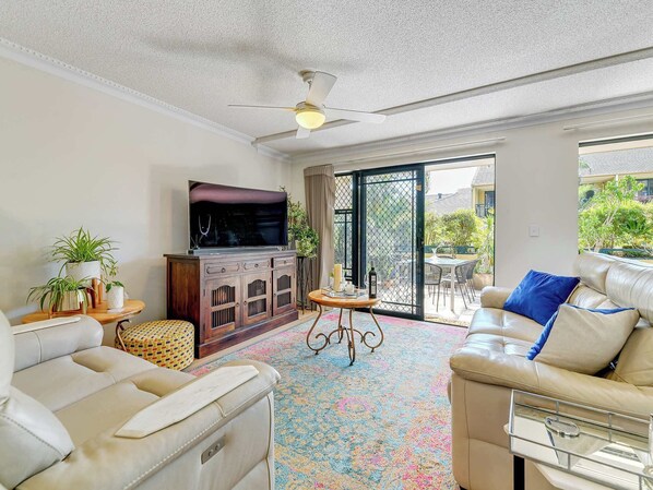 Spacious living room opens out onto patio