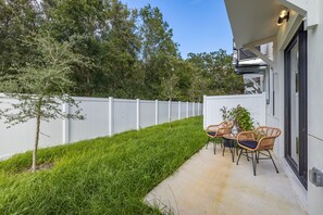 Find your peaceful escape in the backyard, where two inviting chairs await your next moment of relaxation