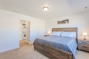 Master bedroom with a plush California king bed and en-suite bath.