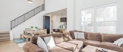 Spacious living area bathed in natural light from the high ceilings.