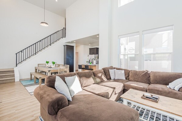 Spacious living area bathed in natural light from the high ceilings.