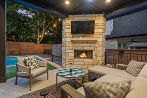 The covered patio area provides additional outdoor lounging space, perfect for enjoying your morning coffee or evening cocktail in the shade.
