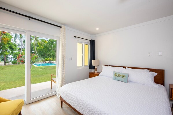 Studio king size bed with porch access and pool views.