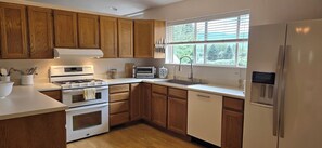 Organized kitchen with high-end equipment and modern appliances.