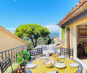 Terrace with barbecue, dining table and lounge seating area - and a magnificent