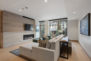 Soak in the beauty of Snowmass through floor-to-ceiling windows that fill the living room with natural light.