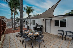 Patio with an outdoor dining area, BBQ grill, picnic table with seating for six