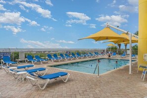 Outdoor pool with ocean views and plenty of lounge chairs. 