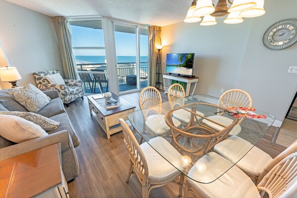 - Wake up to stunning ocean views in this inviting condo, just steps from the beach - Cozy living space with comfy seating, a glass dining table, and a soothing coastal vibe - Enjoy modern comforts, a full kitchen, and easy access to top attractions 