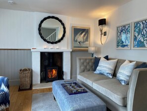 Cosy wood burning stove and relaxing sofa.