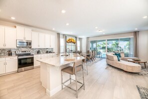 Spacious kitchen with modern appliances and breakfast bar seating up to 3 people