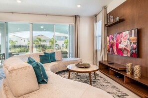 Spacious open plan living area with sectional sofa and flat screen TV