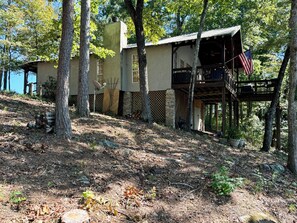side view of cabin, with back porch that looks out to the lake