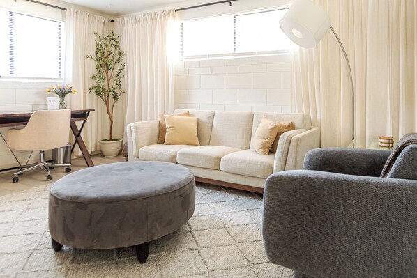 Cozy living area with comfy sofa, workspace and high-speed WiFi