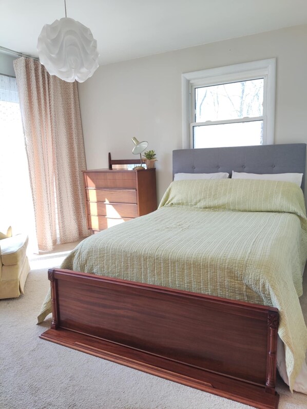 Sliding glass doors lead onto the garden. Blackout curtains lend privacy.