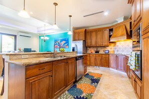 This kitchen is a chef's dream! You'll love the spacious granite countertops, stainless steel appliances, and all the storage. It's fully equipped with everything you need for a quick breakfas