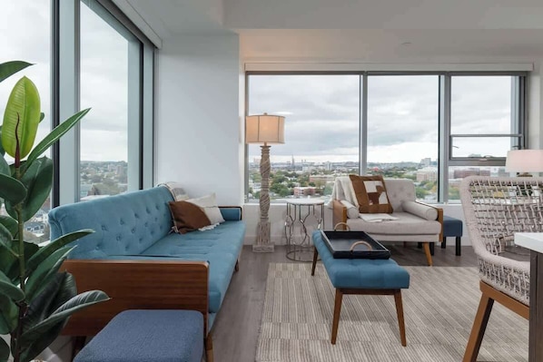 Welcome to your next rooftop retreat! Starting off in the beautiful open living area with city skyline views from the comfort of the selection of stylish sofas. Gaze out into the distance and get ready for your immaculate stay