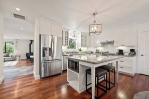 Well equipped kitchen with counter top island and gas stove 