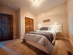 Upstairs guest bedroom with queen bed.