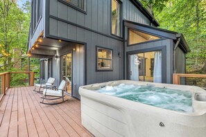 Spacious deck with string lights and hot tub