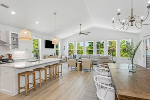 Open concept living area with dining space at both the table and kitchen island