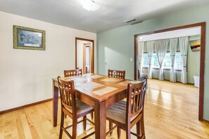 Spacious dining area with a wooden table, seating for four, and easy access to the living room for a seamless flow.
