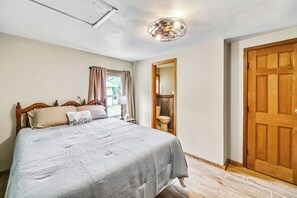 Cozy bedroom with a queen bed, private en-suite bathroom, and plenty of natural light, creating a comfortable retreat.