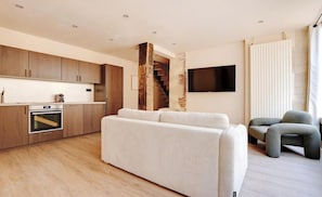 An open-plan kitchen, fully equipped with fridge, freezer, oven, induction hob,