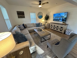 Cozy living room with throw blankets, comfy couch and smart tv.