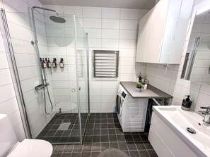 A full bathroom with a washing machine!