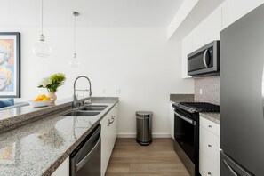 Modern Kitchen Elegance 🍽️ Step into a bright, open-concept kitchen with sleek stainless steel appliances, a spacious granite island, and stylish pendant lighting. Enjoy casual dining at the bar stools or cook with ease in this fully equipped space—perfec