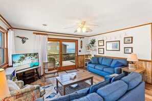 The spacious Living Area is perfect for relaxing with family and friends, offering plenty of seating and natural light.