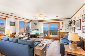 The spacious Living Area is perfect for relaxing with family and friends, offering plenty of seating and natural light.