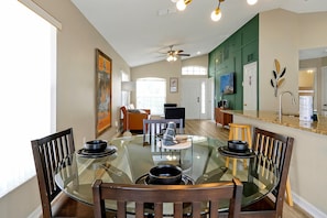 Cozy dining space with a modern chandelier and seating for four, ideal for family meals or casual dining