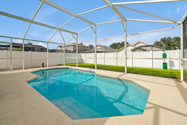 Enjoy the sun by your private, screened-in pool, complete with lounge chairs and a tranquil setting.