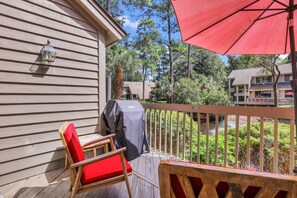 Step outside to the back deck, where you'll find a seating area, an umbrella for shade, and a grill—perfect for enjoying outdoor meals. The Back Deck also has Lagoon Views.