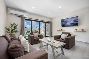 Step into comfort and style in our spacious living room, perfectly designed for family gatherings or a quiet evening in, enjoy plush seating, vibrant décor, and plenty of natural light—your cozy retreat after a day of adventure.