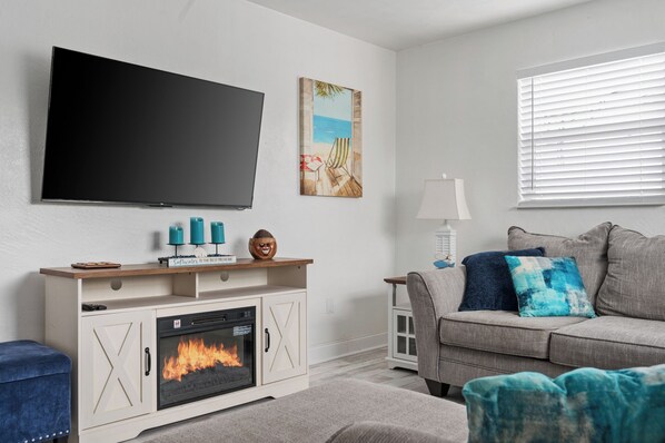 Enjoy the calming ambiance of the living room, adorned with ocean accents for a perfect coastal feel.
