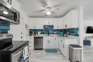 Enjoy cooking in the well-equipped kitchen, complete with all the tools you need for a convenient stay.