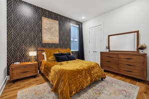 Relax in this beautifully furnished queen bedroom with ample storage and chic decor.