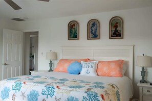 "Unwind in the bright and airy master bedroom with a comfy king-size bed and ocean-inspired touches."