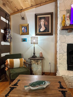 Whether you're sipping coffee by the fireplace, lounging under string lights on the porch, or exploring nearby trails, this cabin offers a memorable getaway with personality. 